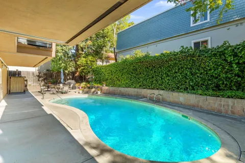 a view of a swimming pool in a backyard