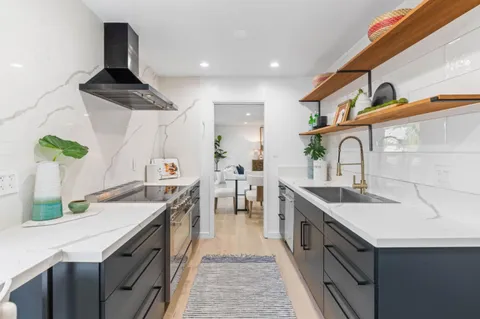 a kitchen with a sink stove and cabinets