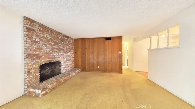 a view of an empty room with a fireplace