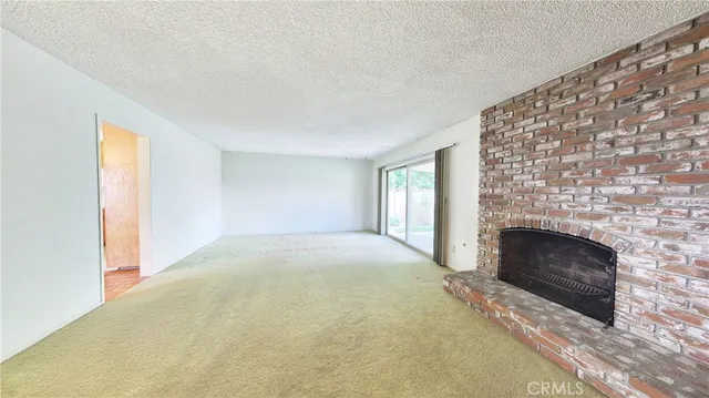 a view of empty room with a fireplace