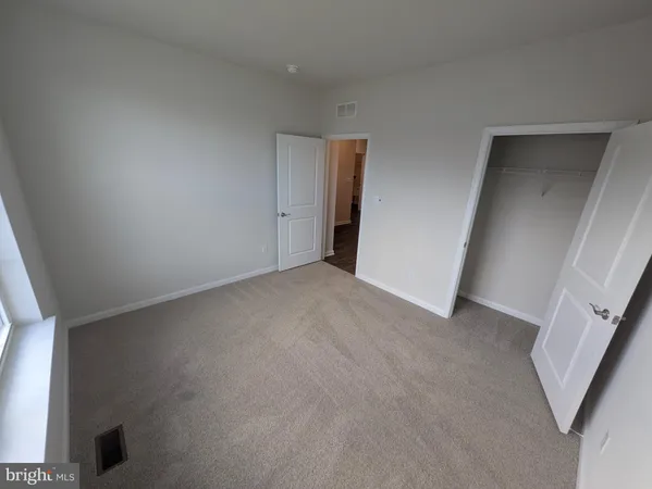 a white toilet sitting next to a bath tub