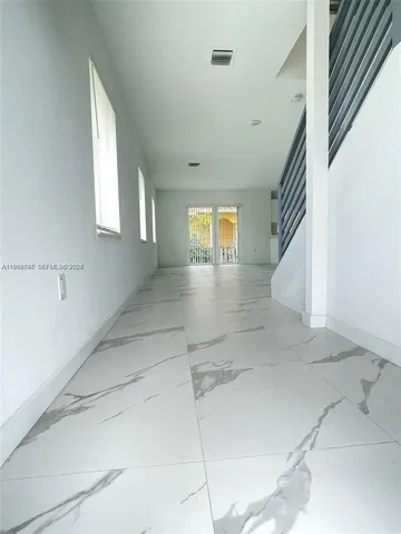 a bathroom with a bathtub shower sink mirror vanity and toilet
