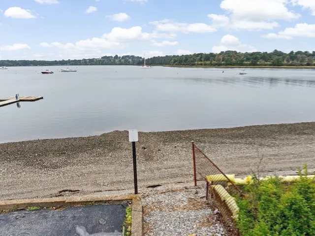 a view of a livingroom with wooden floor and a large window
