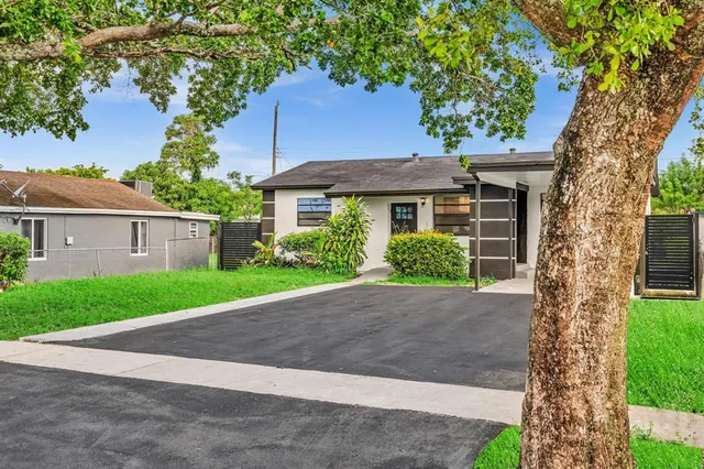 a house with a tree in front of it