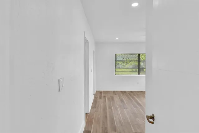 wooden floor in an empty room with a window