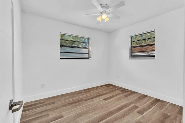 a view of a room with wooden floor and chandelier
