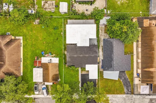 an aerial view of a house with pool and garden