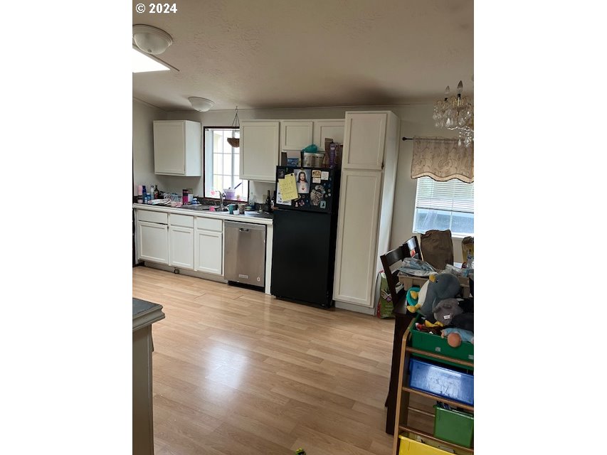 5924 Jessica Lane Springfield, OR 97478 - Photo 9 of 12 a kitchen with a refrigerator cabinets and wooden floor