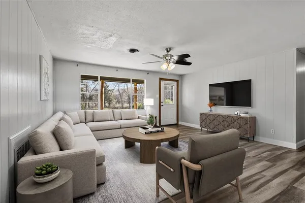 a living room with furniture and a flat screen tv