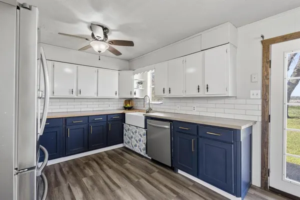 a kitchen with stainless steel appliances granite countertop a refrigerator and a sink