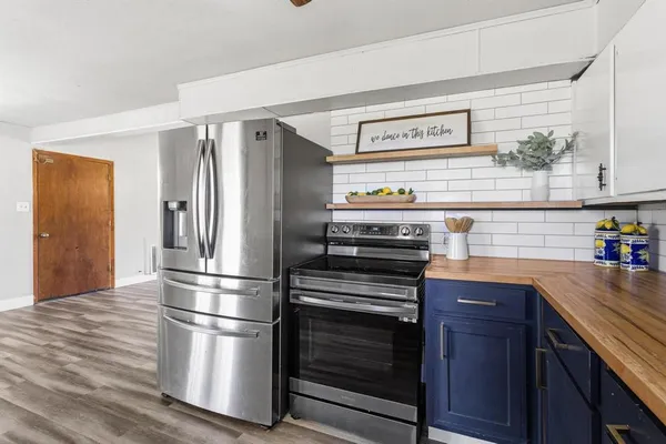 a kitchen with a sink stove and cabinets
