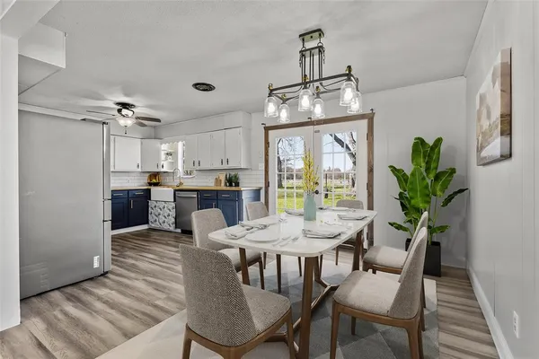an empty room with wooden floor fireplace and windows