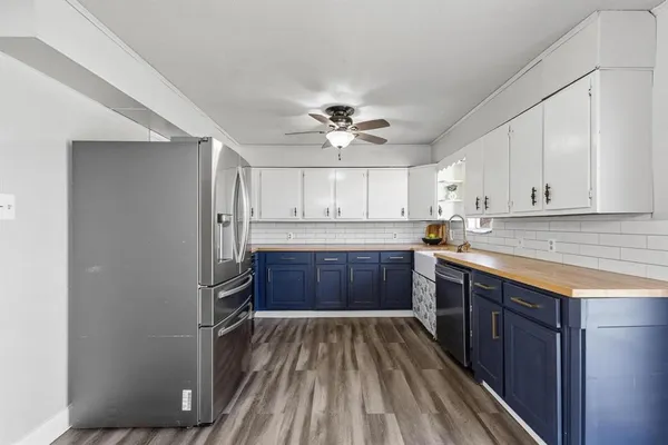 a kitchen with a refrigerator and a sink