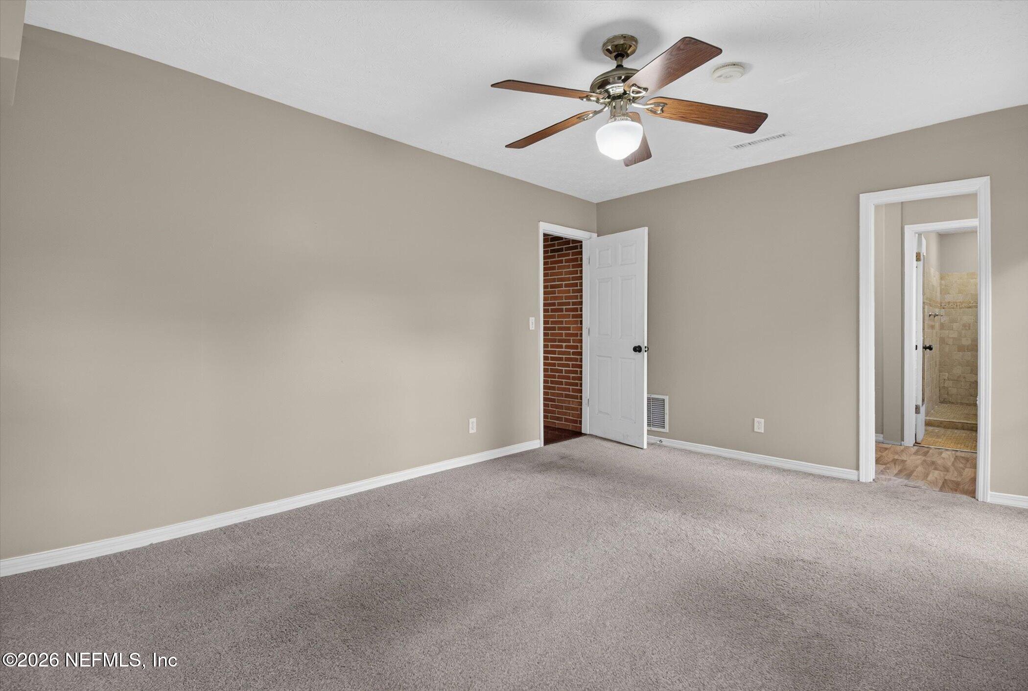 2705 Navajo Road Orange Park, FL 32073 - Photo 36 of 58 a view of an empty room with a chandelier fan