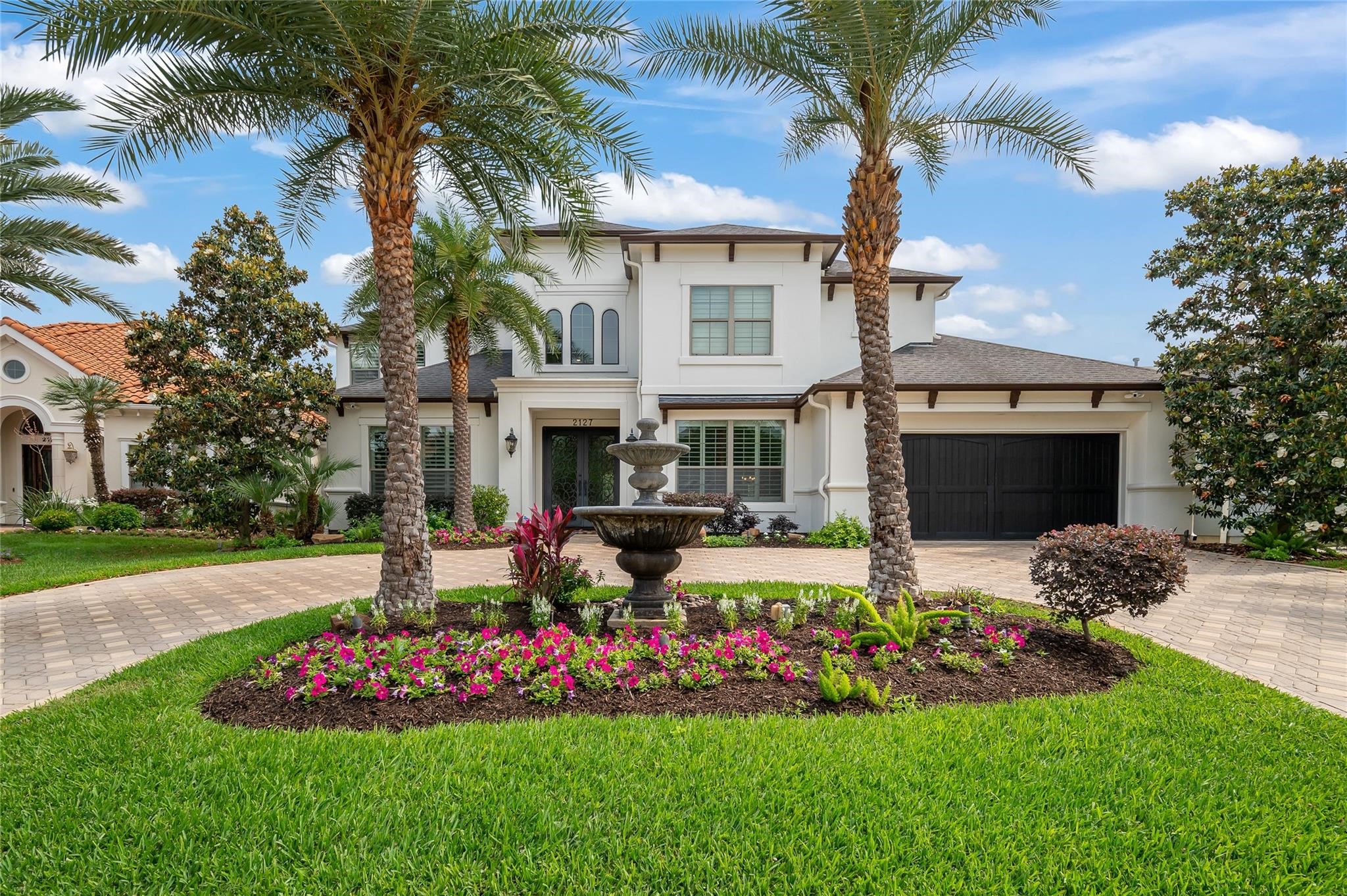 2127 Thicket Ridge Lane Houston, TX 77077 - Photo 1 of 50 Imagine driving up to your new home with this front yard. In addition to the four mature Sylvester Palms, notice the two Magnolia trees that bookend the view of the home.