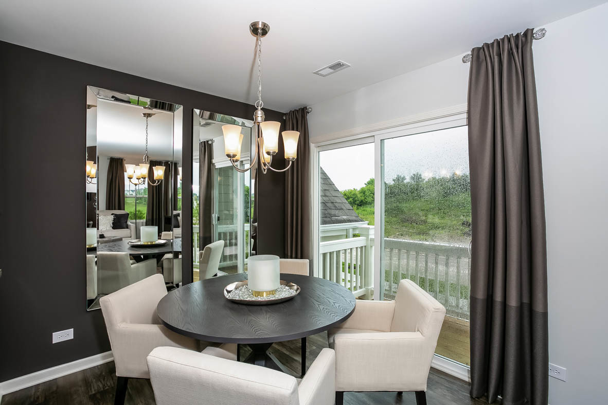 3837 Currant Lane Elgin, IL 60124 - Photo 4 of 10 a dining room with furniture a chandelier and wooden floor