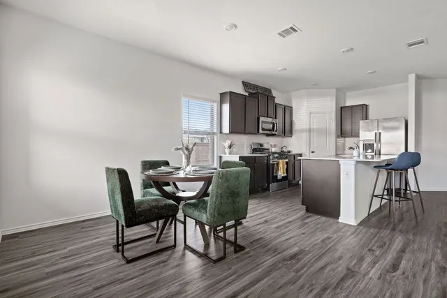 a view of a dining room with furniture and wooden floor