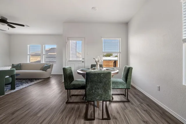 a view of a dining room with furniture and wooden floor