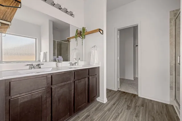 a bathroom with a double vanity sink and mirror