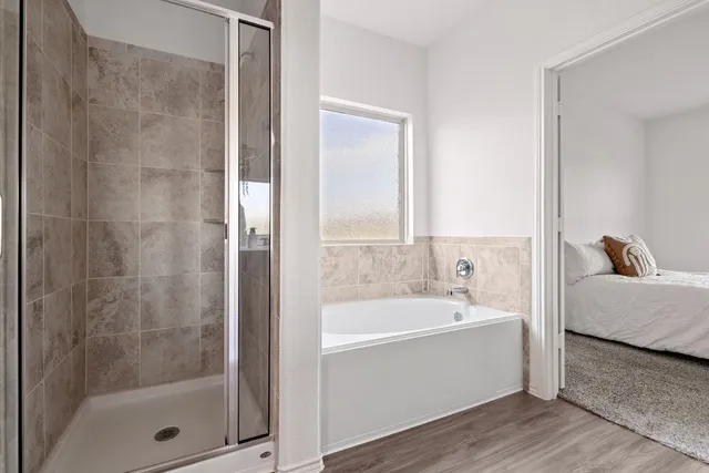 a bathroom with a tub and a shower