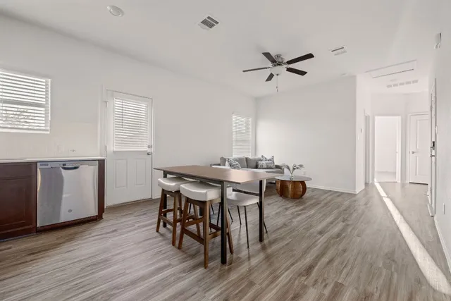 a view of a dining room with furniture and wooden floor