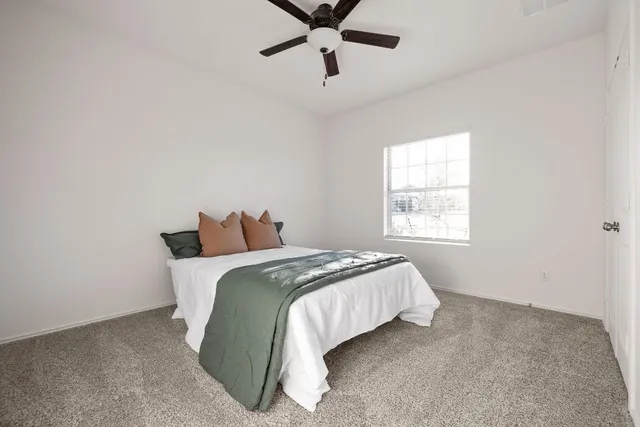 a bed sitting in a bedroom next to a window