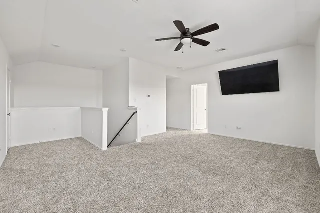a living room with a ceiling fan and a window