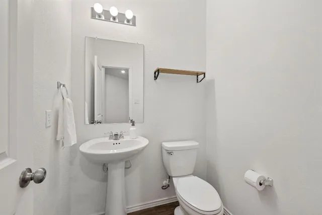 a bathroom with a sink a toilet and mirror