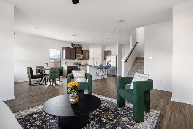 a living room with furniture dining table and a fireplace
