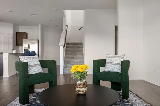 a dining room with furniture potted plant and wooden floor
