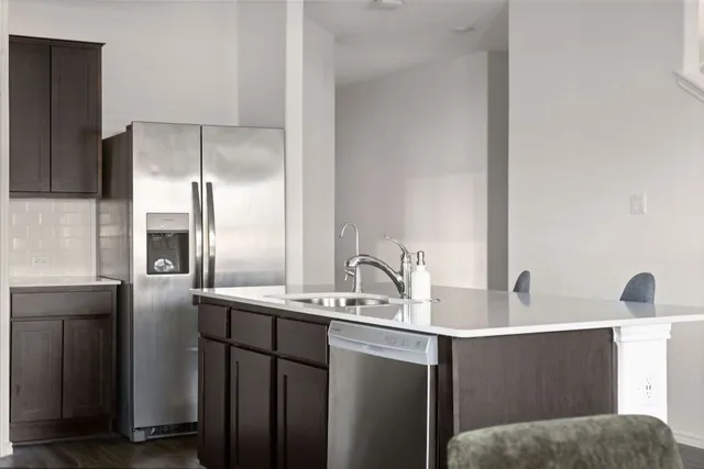 a kitchen with a sink and refrigerator