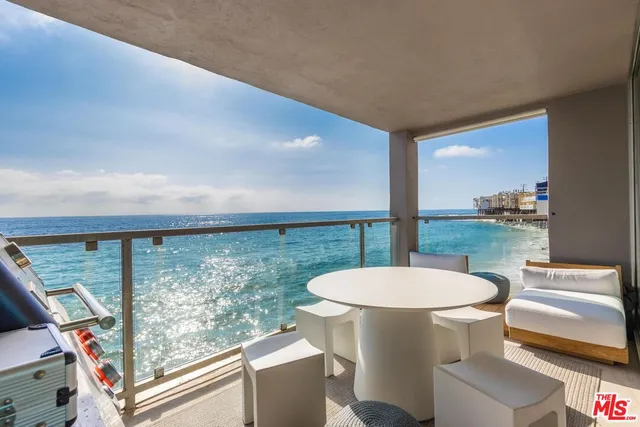 a kitchen with kitchen island a counter top space a sink stainless steel appliances and cabinets