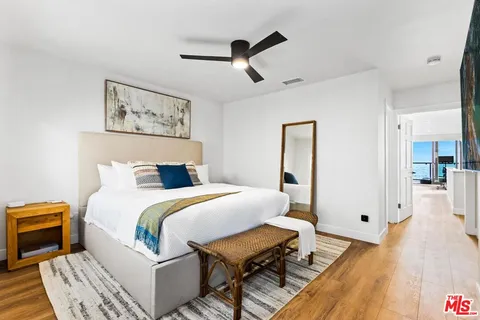 a bathroom with a bathtub shower sink mirror and toilet