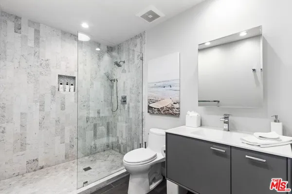 a bedroom with a bed and large window