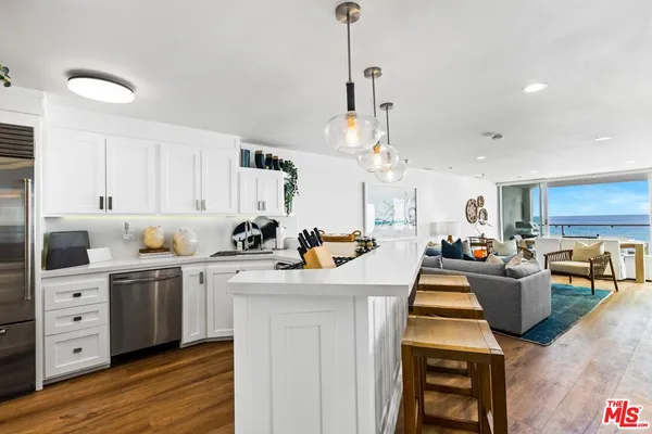 a kitchen with a stove cabinets and wooden floor