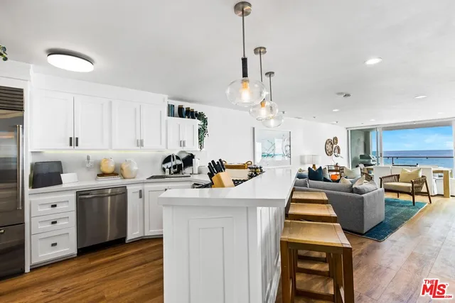 a kitchen with a stove cabinets and wooden floor