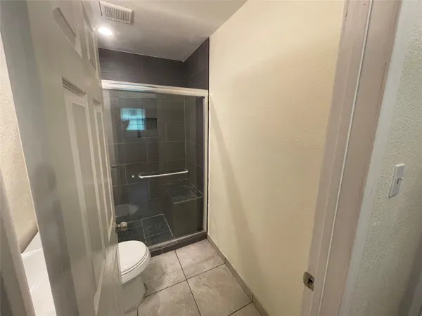 a bathroom with a glass door shower