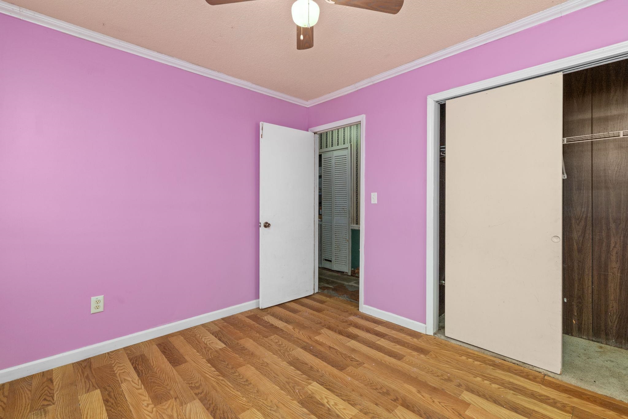 60116 Seminole Road Smithville, MS 38870 - Photo 24 of 38 Wood-finish flooring, ceiling fan with integrated lighting, and a sliding closet door