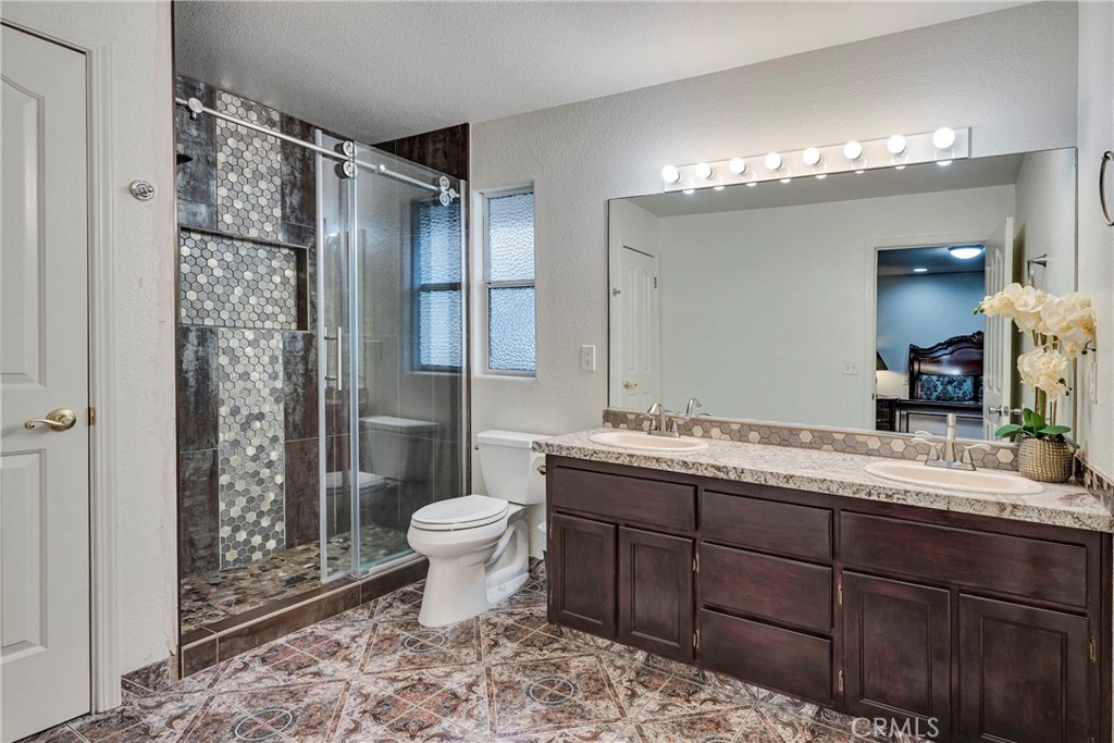 18230 Hidden Valley Road Hidden Valley Lake, CA 95467 - Photo 13 of 22 a bathroom with a double vanity sink toilet and shower