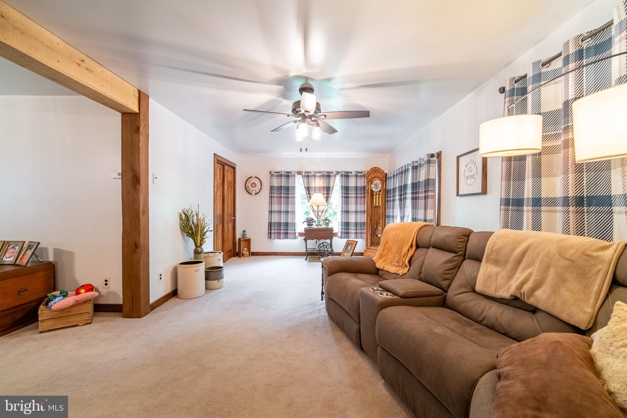 13127 Manor Furnace Road Brogue, PA 17309 - Photo 21 of 78 a living room with furniture and a chandelier