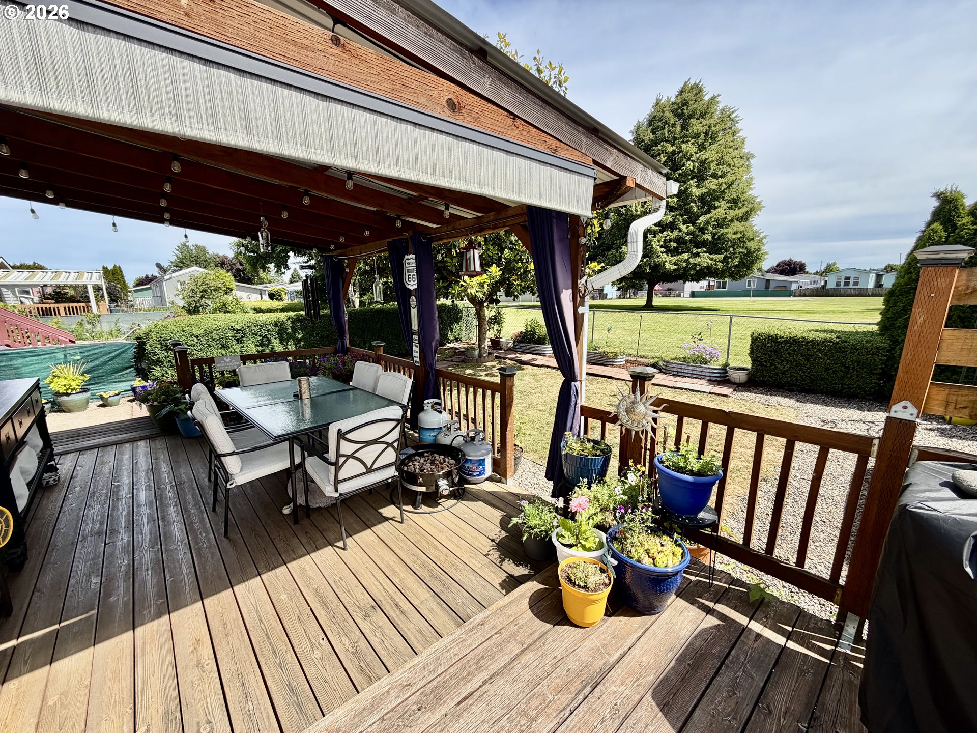 1699 North Terry Street, Unit 351 Eugene, OR 97402 - Photo 13 of 23 a view of a patio with lawn chairs and wooden floor