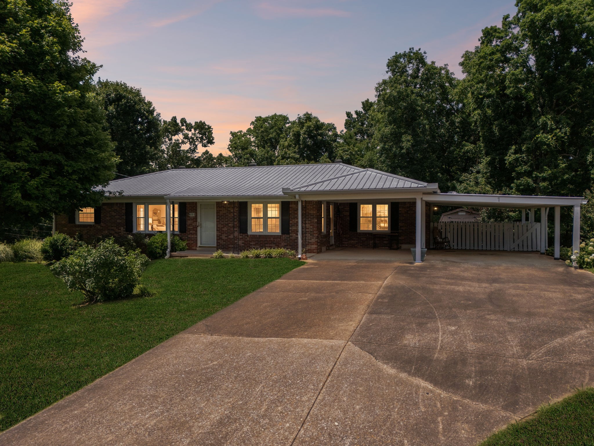 708 Hickory Street Centerville, TN 37033 - Photo 2 of 57 a front view of a house with a garden