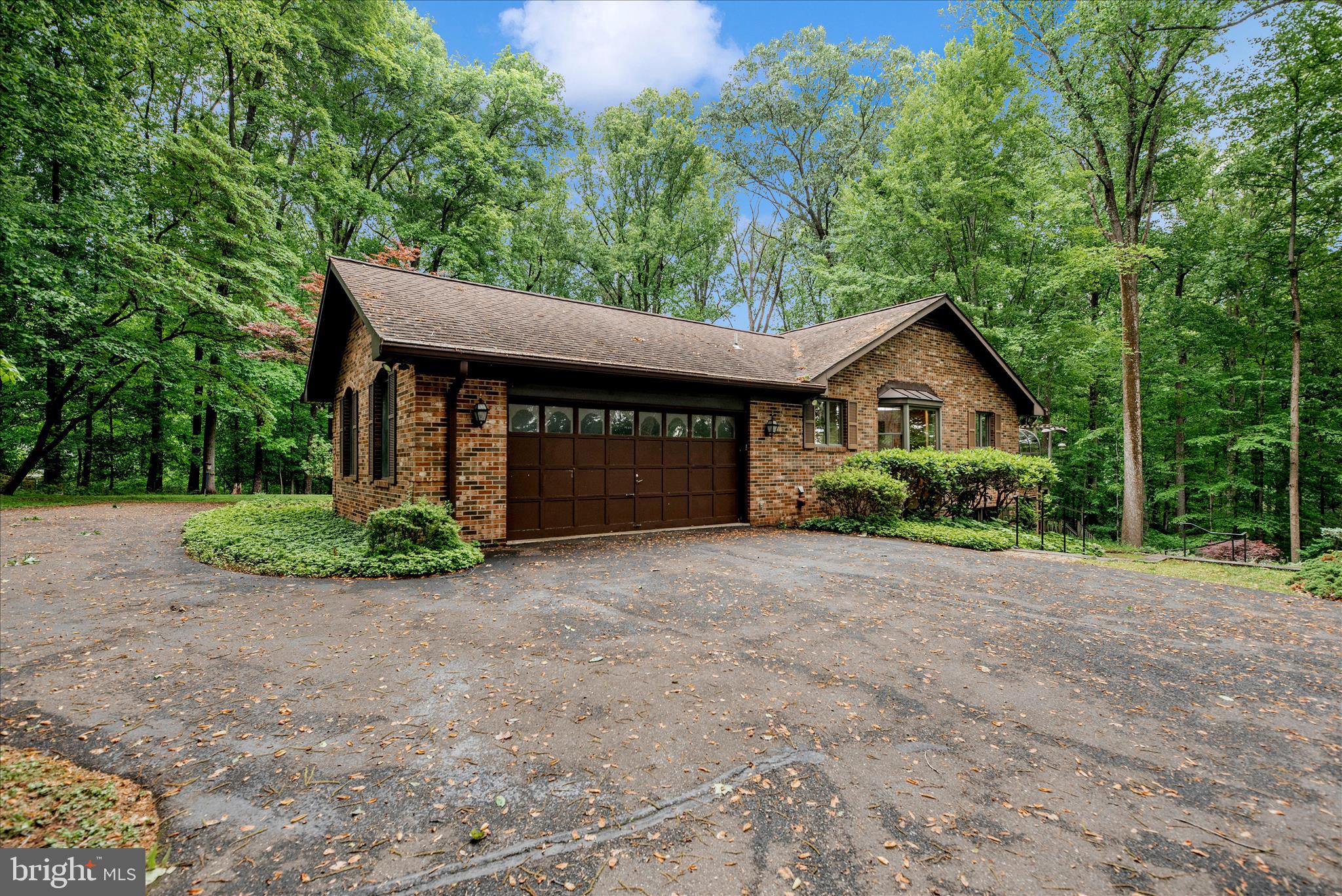 2221 Gold Mine Road Brookeville, MD 20833 - Photo 54 of 60 a front view of a house with a yard and garage