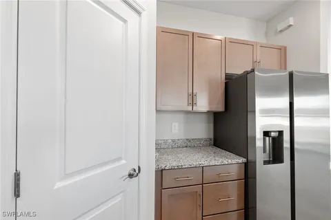 a kitchen with a refrigerator and cabinets