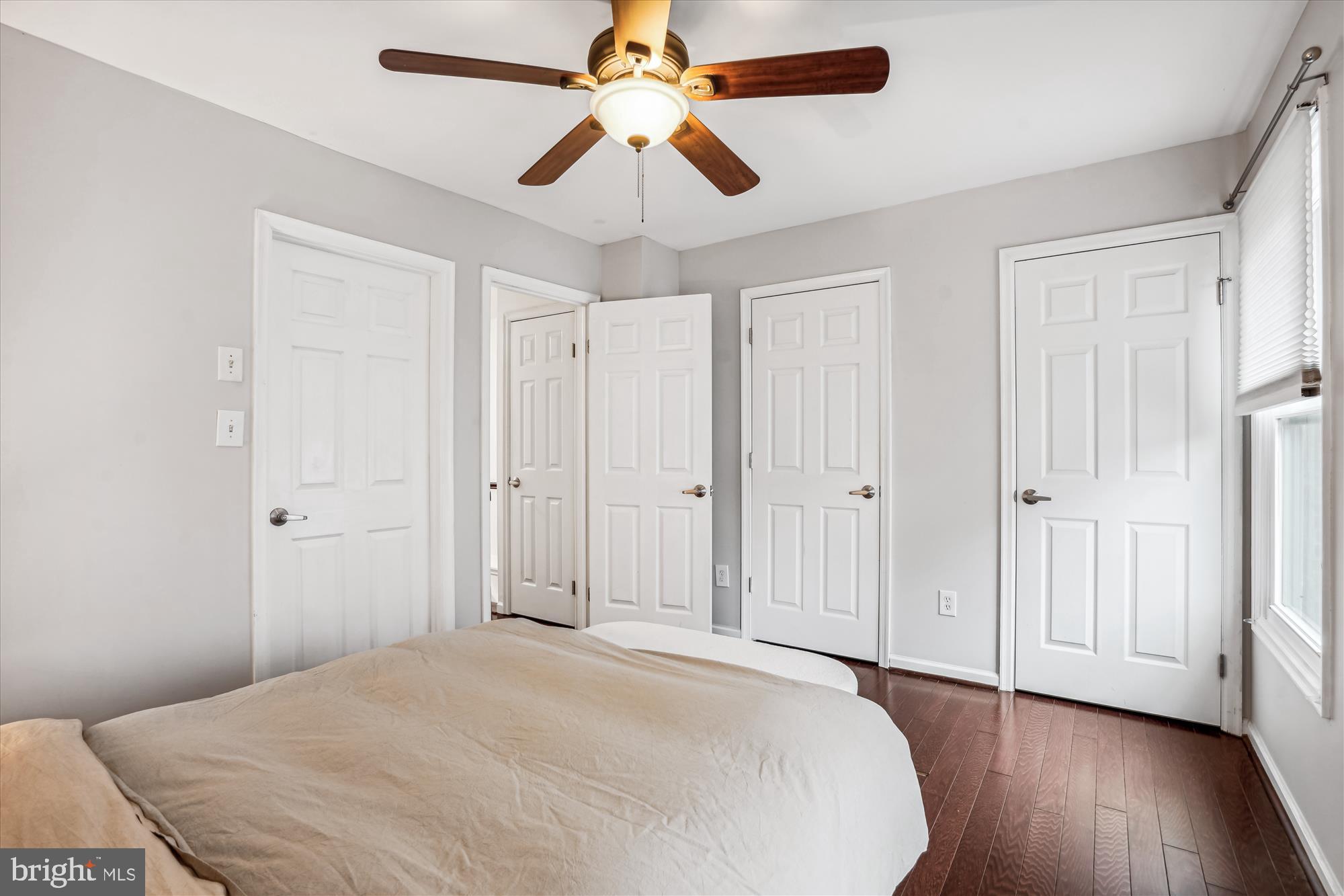 5039 9th Street South Arlington, VA 22204 - Photo 15 of 38 a view of a bedroom with wooden floor and a ceiling fan