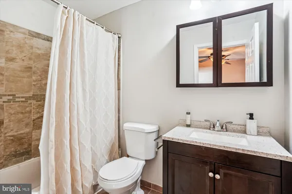 a bathroom with a toilet a sink and a mirror