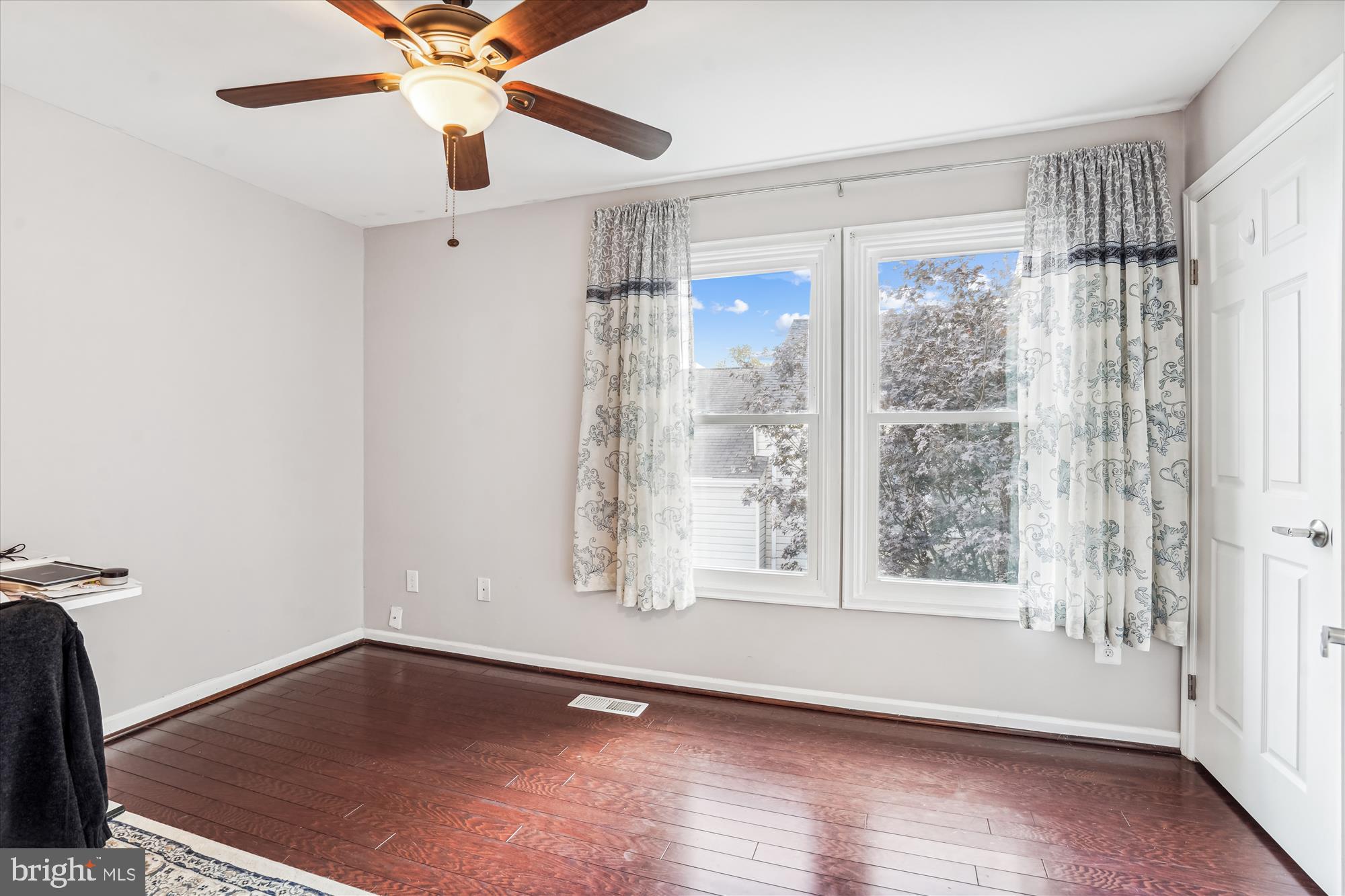 5039 9th Street South Arlington, VA 22204 - Photo 17 of 38 a view of an empty room with a window and wooden floor