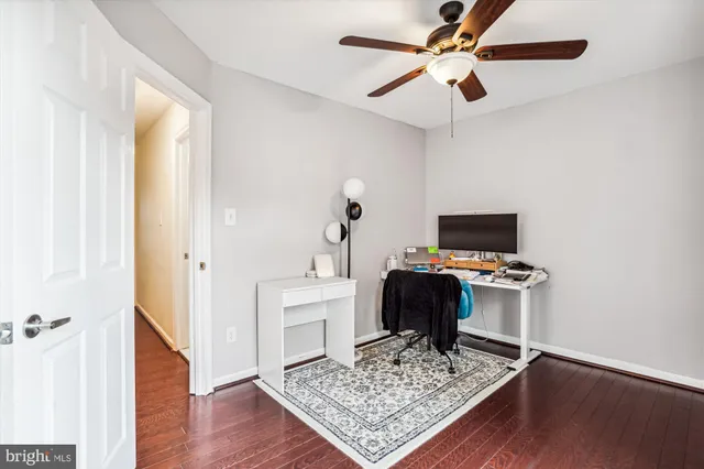 a view of workspace with wooden floor stairs and a window