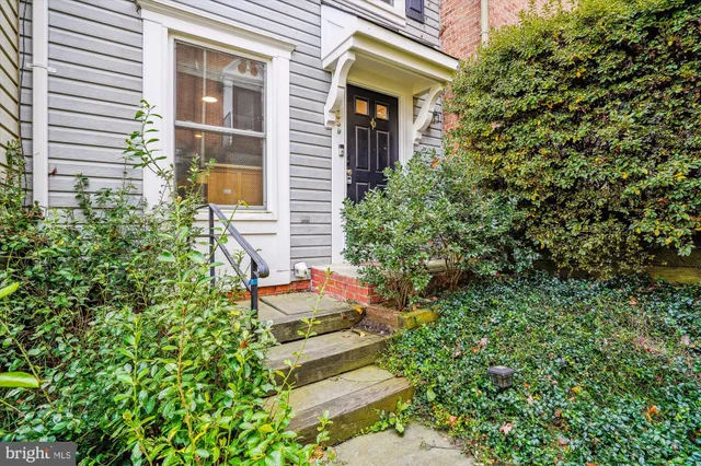 a backyard of a house with outdoor seating