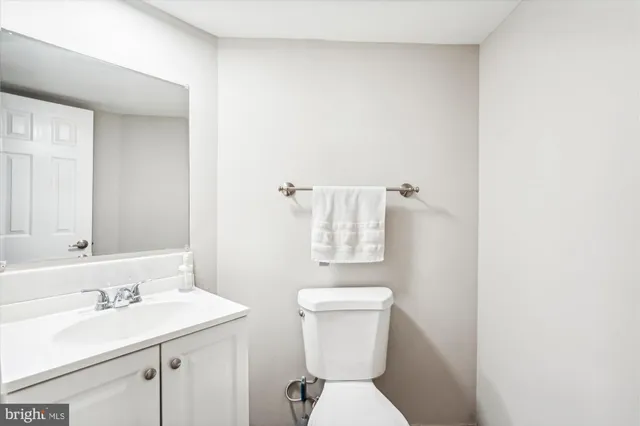 a bathroom with a toilet a sink and mirror
